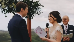 A loving couple standing close together, holding their wedding vows, sharing an intimate moment during their wedding ceremony.